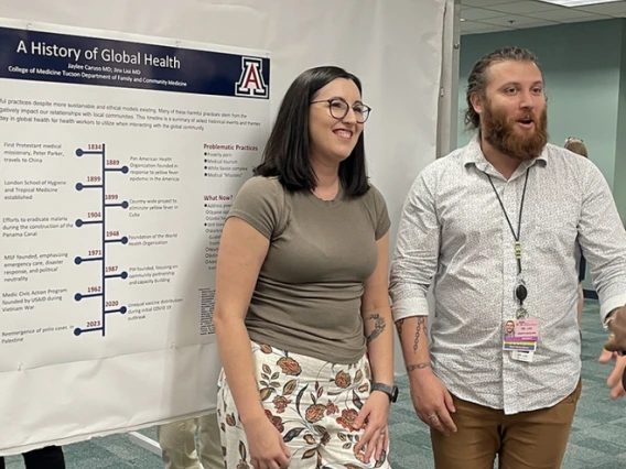 2 doctors with research poster