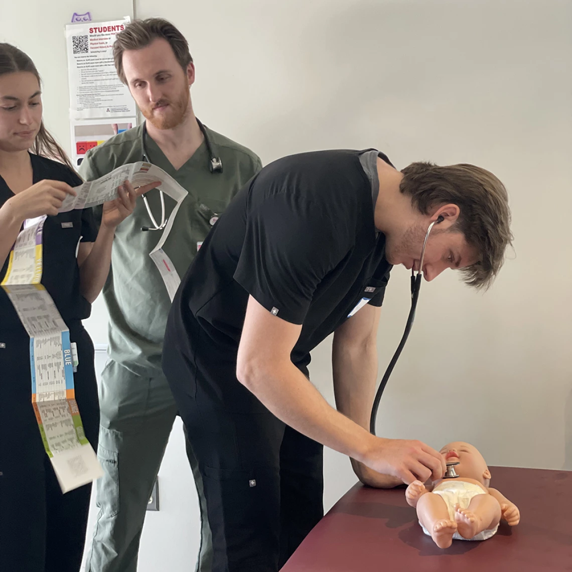 student doctor examining a baby